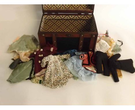 Small dome top trunk containing a quantity of tiny stitched dolls clothes  