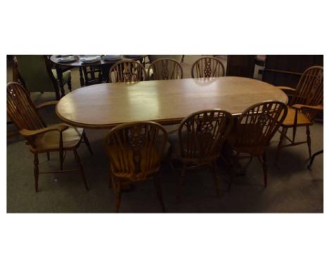 Early/mid-20th century solid oak small refectory table, oval shaped raised on two carved baluster end supports with base stre