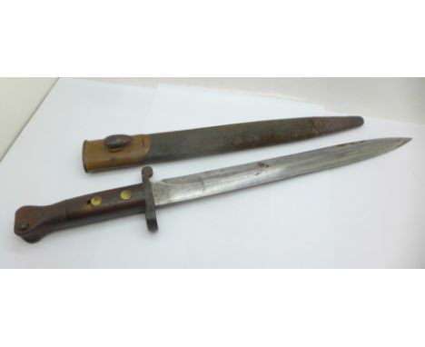 A British late 19th Century bayonet with scabbard, the blade marked, VR 1 98, also EFD under broad arrow 