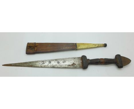 An early 20th Century African dagger with a worked leather handle and leather and snakeskin sheath, length of dagger 31cm 