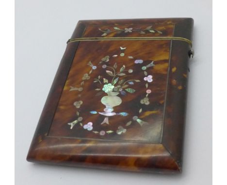 A tortoiseshell and inlaid mother of pearl card case, 77mm x 105mm, a/f, damage at the hinge 