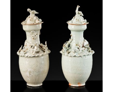 A PAIR OF QINGBAI FUNERARY JARS AND COVERS WITH THE 'GREEN DRAGON' OF THE EAST AND THE 'WHITE TIGER' OF THE WEST, SONG DYNAST