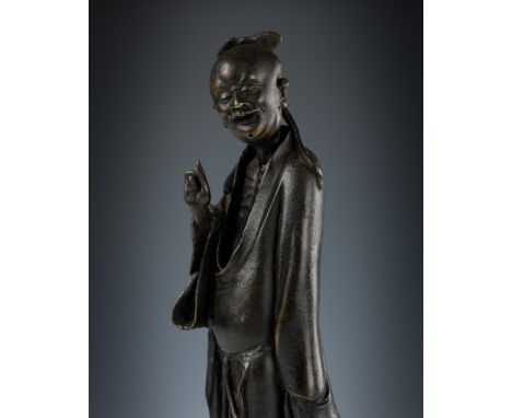 A BRONZE FIGURE OF AN IMMORTAL, LATE MING DYNASTY 明末仙人銅像China, 16th-17th century. Well modeled standing on a naturalistically