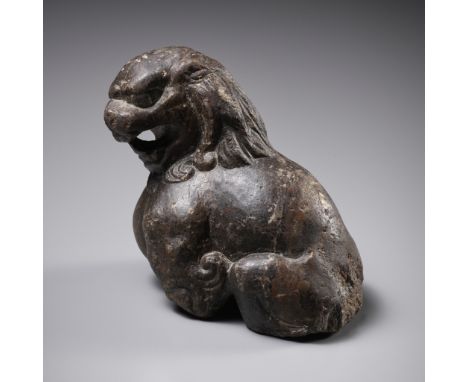 A BROWN LIMESTONE FIGURE OF A SEATED LION, TANG DYNASTY 唐代石獅China, 618-906. The muscular animal shown seated, the head turned