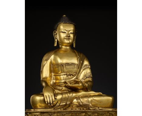 A LARGE GILT-BRONZE FIGURE OF BUDDHA SHAKYAMUNI, KANGXI TO YONGZHENG PERIOD 康熙至雍正時期銅鎏金釋迦牟尼像China, 1662-1735. Superbly cast, s