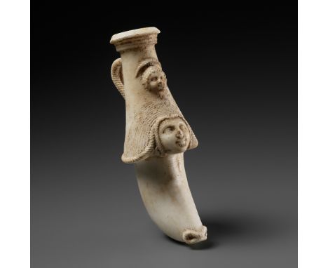 A WESTERN ASIATIC ALABASTER RHYTON WITH MOTHER GODDESS AND CHILD2nd to 3rd century AD. The curved rhyton with a tiered circul