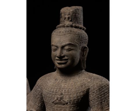 A RARE AND LARGE SANDSTONE FIGURE OF RADIATING LOKESHVARA, KHMER EMPIRE, ANGKOR PERIODLate 12th to early 13th century. Boldly