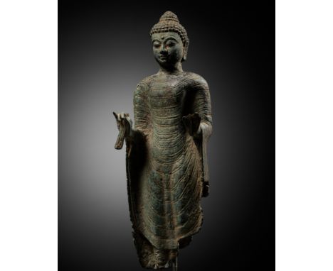 A FRAGMENTARY BRONZE BUST OF BUDDHA, INDONESIA, 16TH-17TH CENTURYFinely cast dressed in a monastic robe covering both shoulde