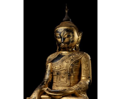 A LARGE GILT-LACQUERED WOOD FIGURE OF BUDDHA SHAKYAMUNIBurma, 19th century. Seated in dhyanasana on a pedestal neatly incised