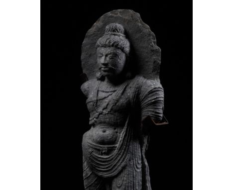 A GRAY SCHIST FIGURE OF MAITREYA, ANCIENT REGION OF GANDHARACirca 5th-7th century. Well carved standing, dressed in a finely 