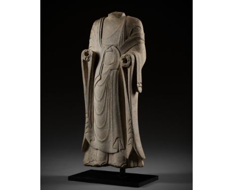 A LARGE AND HIGHLY IMPORTANT WHITE MARBLE TORSO OF BUDDHA, NOTHERN QI DYNASTY 北齊大型漢白玉立佛殘件China, 6th century. Depicting a stan