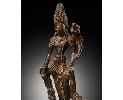 A STONE FIGURE OF PADMAPANINepal, 19th century or earlier. Standing in tribhanga on a short rectangular base, the right hand 