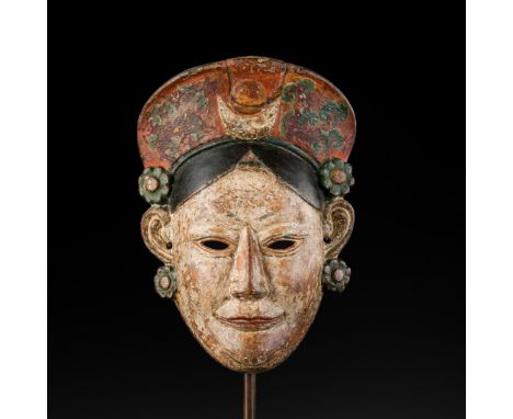 A POLYCHROME WOOD MONPA MASK, 19TH CENTURYArunachal Pradesh, India. Finely carved as a woman with a gentle smile below almond