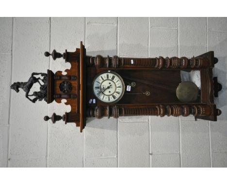 A 19TH CENTURY WALNUT CASED EIGHT DAY GUSTAV BECKER WALL CLOCK, the pediment depicting  horse, two finials, above and arched 