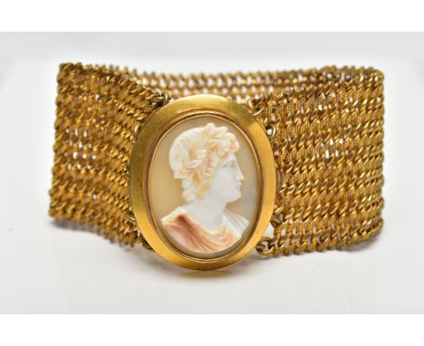 A YELLOW METAL AND SHELL CAMEO BRACELET, a wide yellow metal mesh bracelet, approximate width 37mm, featuring an oval yellow 