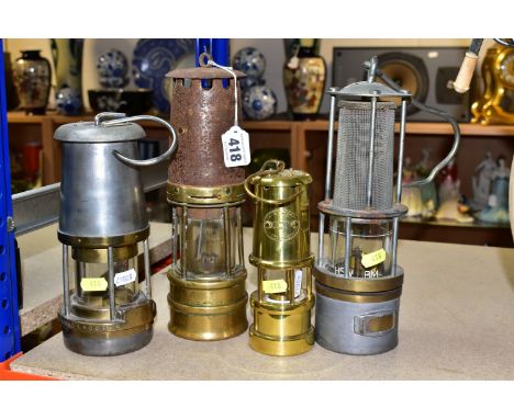 A GROUP OF FOUR MINER'S LAMPS, comprising a brass and steel miner's lamp stamped 109, height 26cm (well worn, top has rusted)