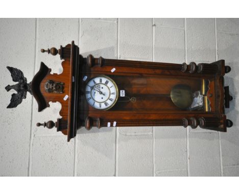 A 19TH CENTURY WALNUT CASED EIGHT DAY GUSTAV BECKER WALL CLOCK, the pediment depicting an eagle, above a face, two finials, a