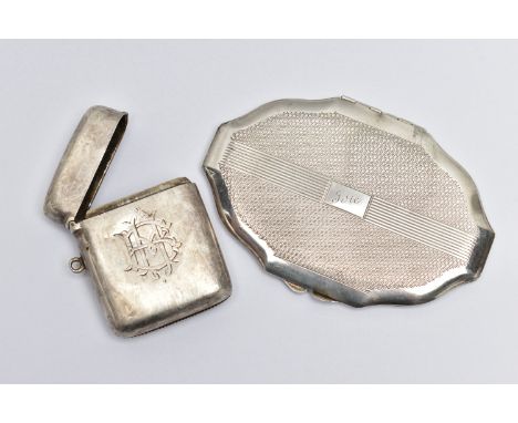 A SILVER VESTA CASE AND A COMPACT, the vesta of a rounded rectangular form, polished design with engraved monogram to the fro