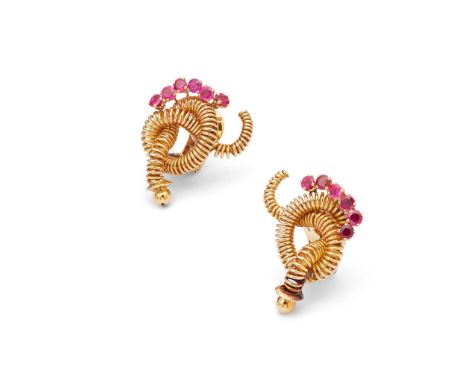  Mellerio: A pair of ruby earclip, circa 1950  Each wirework tubular openwork knot, accented by a line of circular-cut rubies