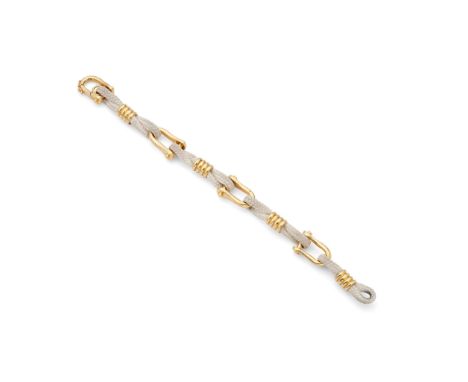  Boucheron: A cord and shackle bracelet  The series of white cord in figure-of-eights, centrally set with reeded barrel accen