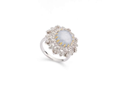  A star sapphire and diamond ring  The circular cabochon star sapphire, within an elaborate pierced surround set with brillia