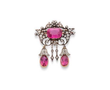  A pink tourmaline and diamond brooch  Of scrolling foliate form, centrally set with a cushion-shaped pink tourmaline, highli