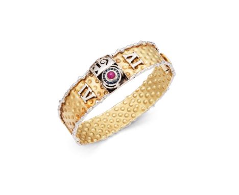  Cetas: A bi-coloured gem-set bangle  The hinged bangle, centrally set with a rectangular panel featuring a circular cabochon