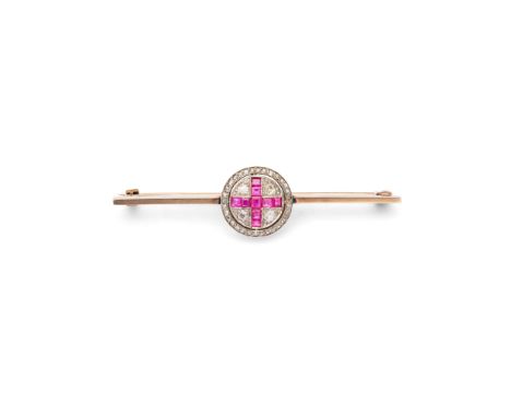  A ruby and diamond bar brooch, first half of the 20th century  The polished bar brooch, centrally featuring a circular motif