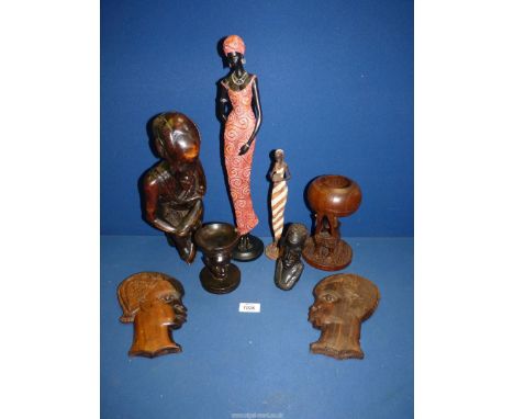 Two wooden face wall plaques, a wooden sculpture of a man sitting with a water flask, carved ashtray and a carved bust of a m