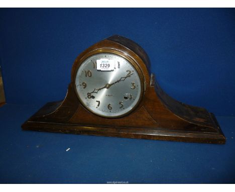 A dark-wood cased cheval design Mantel Clock having a two-train movement striking on bar gongs, the silver coloured face havi