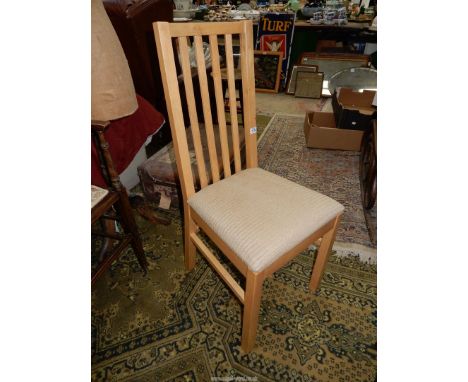 A light hardwood framed modern side Chair with a beige upholstered seat.