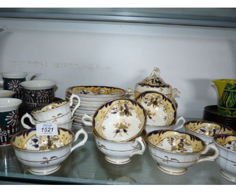 A part tea set in blue &amp; yellow pattern including seven teacups, three coffee cups, eleven saucers and a sucrier, a/f.