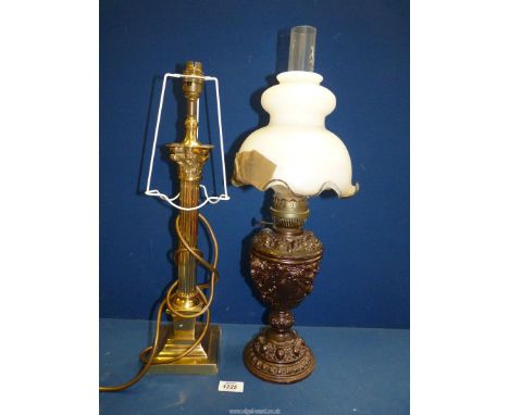 An oriental oil Lamp with cast metal base, clear chimney and white shade, a/f, 22" tall, and a brass effect corinithian colum