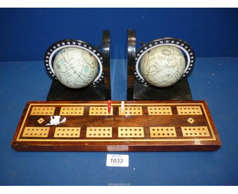 A Jaques of London Mahogany and Satinwood Cribbage Board on pill feet (pegs in well), 14'' long and a pair of globe bookends.