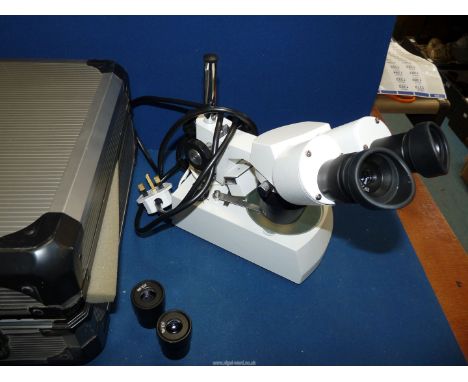 A compact Binocular Microscope, multi-lens, in aluminium case.