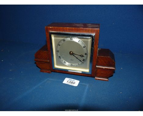 An oak cased Art Deco  design square faces mantel clock having silvered chapter ring with Roman numerals. 'An Elliot Clock' n
