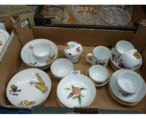 A quantity of Royal Worcester 'Evesham' china  including cereal and pudding dishes, cups, saucers etc, some chips and repairs