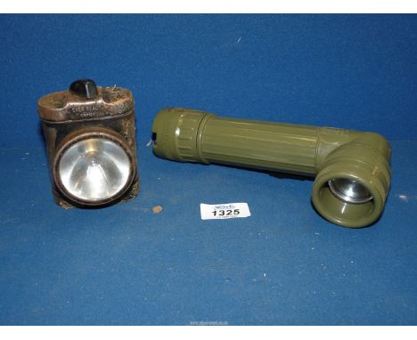 A military style Khaki coloured plastic/bakelite cased Torch marked "US MX991/U" designed to operate on two "C" type cells an