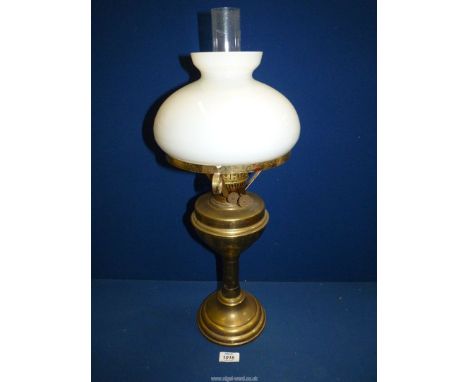 A Victorian brass oil Lamp with white shade and clear chimney, 24" tall.