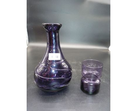 A 20th c. heavy purple glass vase with random applied trails and a purple waisted Holmegaard Danish vase.