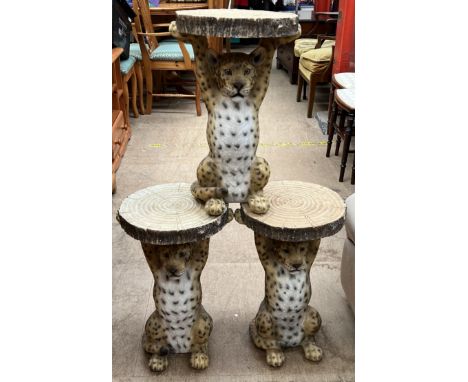 A set of three novelty wine tables in the form of a leopard holding a tree ring 