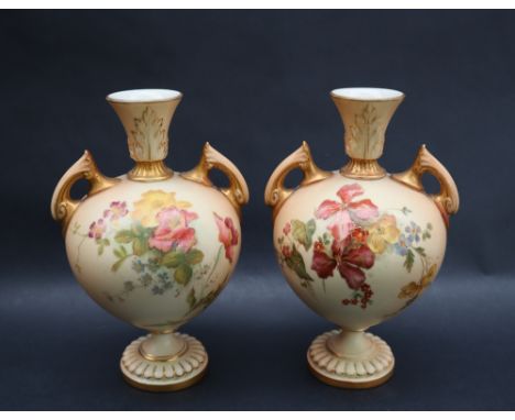 A pair of Royal Worcester porcelain twin handled vases transfer and infill decorated with flowers and leaves, green mark, 17c