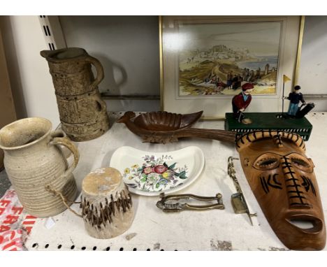 A Birdie putt money box together with pottery jugs, mask, nut cracker, watercolour etc 