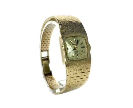 LADY'S ACCURIST NINE CARAT GOLD MANUAL WIND WRIST WATCH, the rounded square dial with applied black and gold hour markers, pe