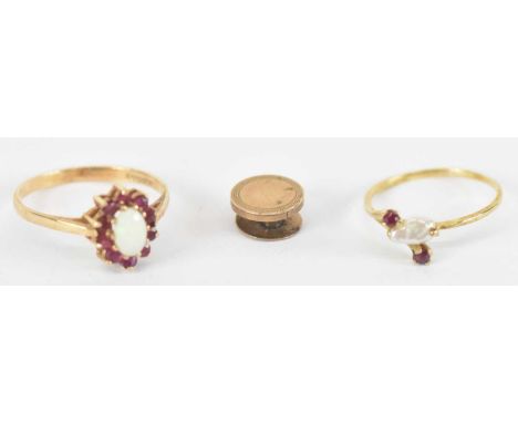 A 9ct yellow gold opal and red stone set ring, size Q, a 9ct yellow gold seed pearl and ruby set ring, size L, and a 9ct yell