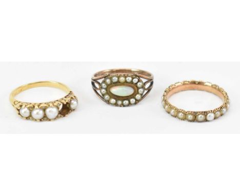 A Georgian style yellow metal seed pearl eternity ring, a yellow metal pearl set ring (one absent) and an opal and seed pearl
