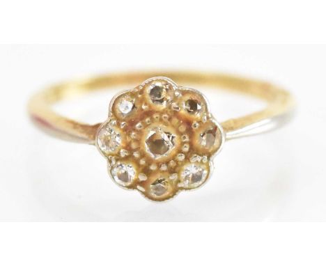 A 9ct yellow gold diamond flower head ring, set with central diamond surrounded by eight smaller diamonds, size M, approx 2.3