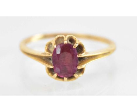 A yellow metal ruby set ring, the central ruby approx 0.75ct, size K, approx 3.4g.