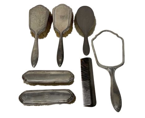 CHARLES HENRY DUMENIL; a George V hallmarked silver five piece dressing table set including hand mirror, two hand brushes and