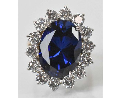 A 9ct yellow gold dress ring, set with large central blue stone surrounded by fourteen small white stones, size O, approx 10.